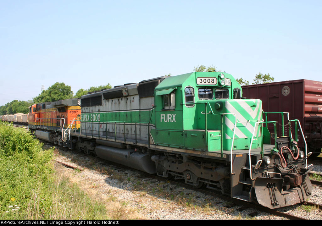 FURX 3008 & BNSF 4897 sit in a siding as a CSX train rolls by